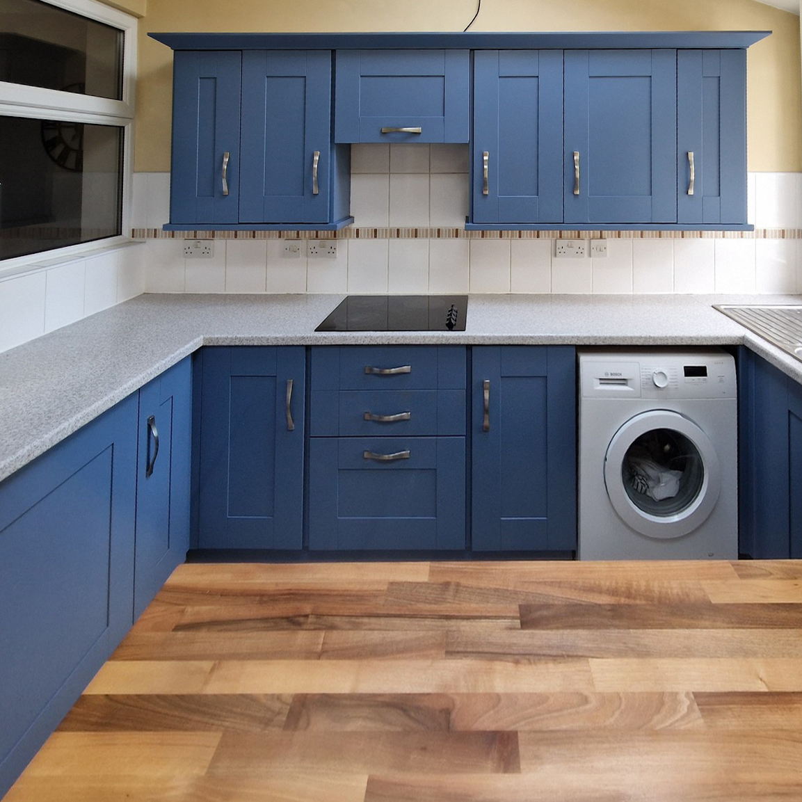 Kitchen front angle looking at fresh sprayed pigeon blue panels